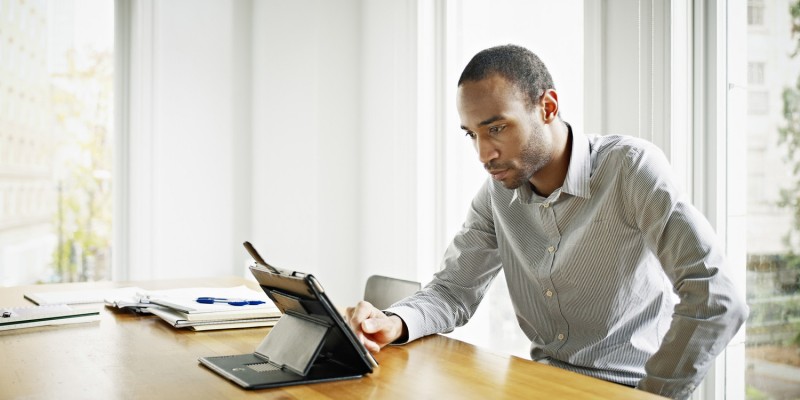 Businessman in office working on digital tablet